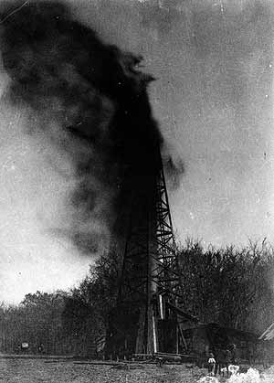 A crowd watches the Indian Territory's first oil gusher in 1897.