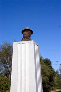 Bronze bust of Joe Roughneck in Texas park.