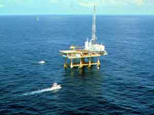 Charter fishing boats visit a drilling rig off Louisiana in the Gulf of Mexico.