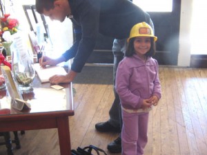 A young visitor wears a plastic hardhat during her visit to the oil museum in Luling, TX.