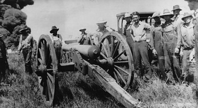 Cannon fires at burning oil tanks from the collection of the Kansas Oil Museum, circa 1930s.