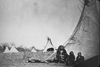 Native Americans sit at Tepees.
