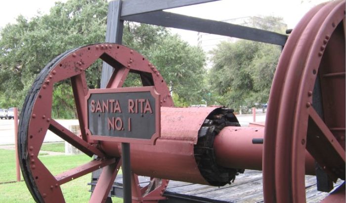 Bull wheel of Santa Rita drilling rig at University of Texas outdoor display.
