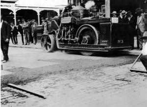 As roads improved after WWI, workers apply oil-based asphalt to a road.