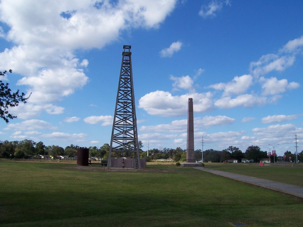 Spindletop Boom Town Museum outdoor exhibits and granite marker.
