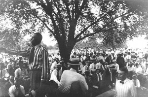 Circa 1920s photo of E.E. Walters auctioning Osage leases in shade of Elm tree