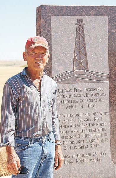 First North Dakota oil well where Cliff Iverson stands by his well's monument erected in 1953.