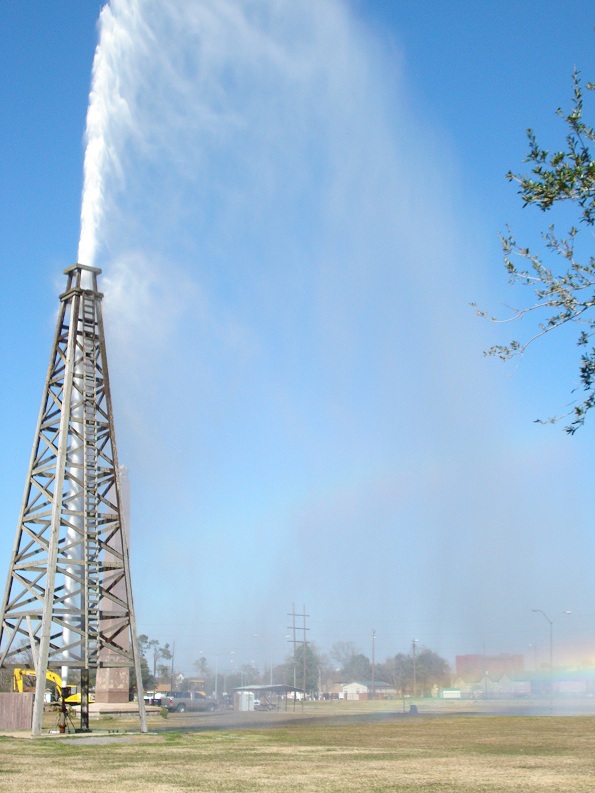 A Spindletop oil museum's derrick's water gusher demonstration produces a rainbow.