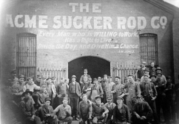 Workers pose at Acme Sucker Rod Company building.