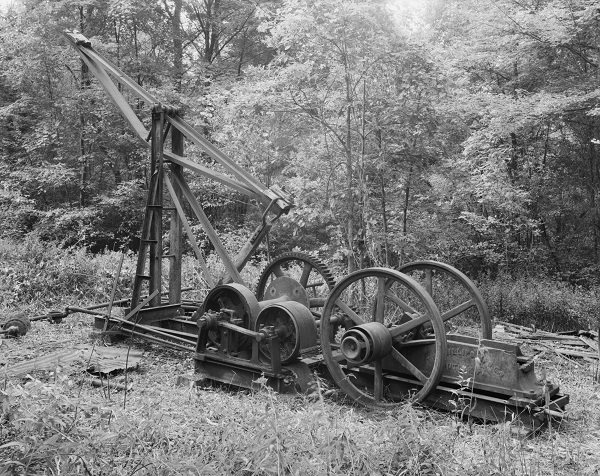 A 1992 photograph of a circa 1914 oil pumping jack, gears and flywheels found in Pennsylvania woods.