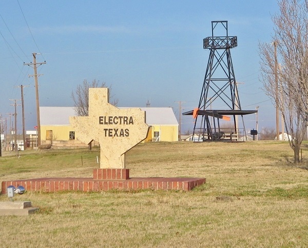 Electra, Texas, oil pump and welcome sign entering town.