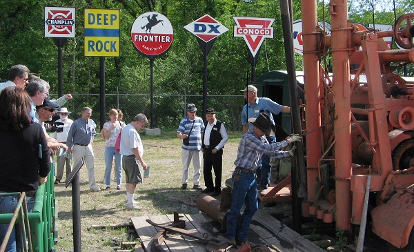 Volunteers at Kansas Oil Museum demonstrate antique oil well "spudder."