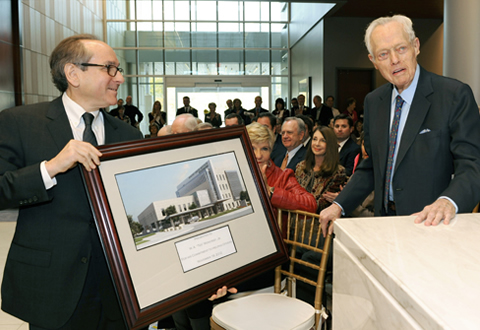 Dr. Daniel Podolsky in 2013 presents W.A. “Tex” Moncrief Jr. with a framed image of the new Moncrief Cancer Institute.