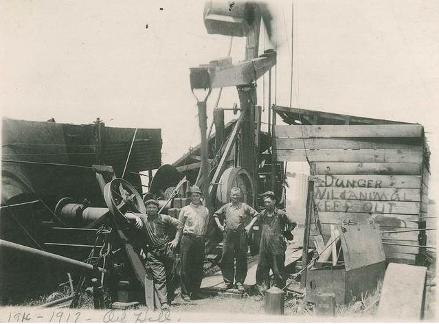 Roughnecks pose in from of Kansas oil well circa 1930.