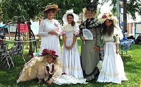 Women of Paola Kansas dressed in 19th century outfits for annual natural gas festival.