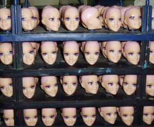 Rows of plastic Barbie heads made from petroleum products.