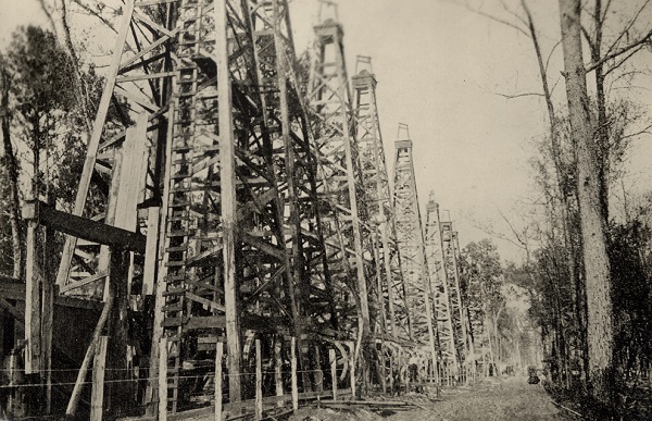 Wooden derricks crowd together at Sour Lake , Texas, circa 1910.