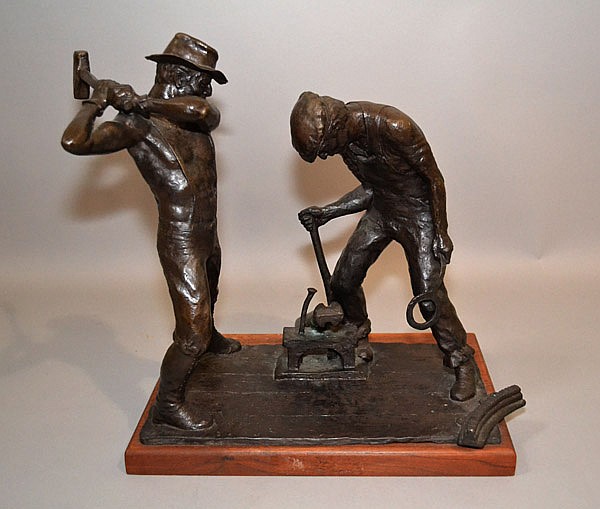 A 15-inch bronze sculpture by Lincoln H. Fox titled, "Dressing the Bit," depicts two workers with early percussion-drilling tools. 