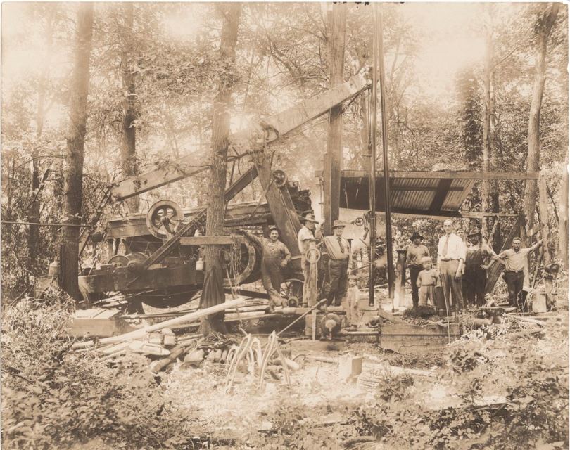 Oil well with visitors in Miami County, Kansas, circa 1920.