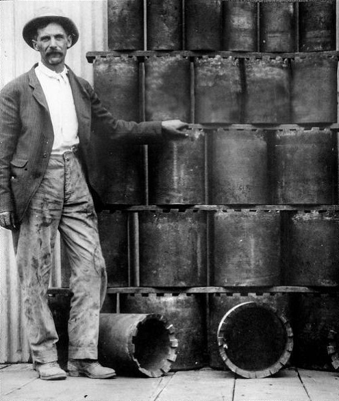 R.C. "Carl" Baker standing next to Baker Casing Shoes in 1914. 