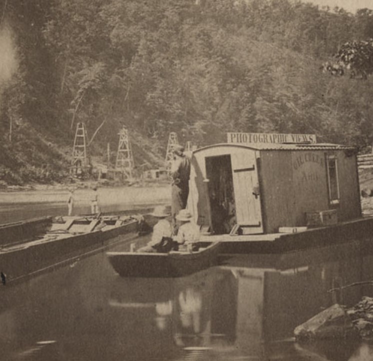 John Mather's floating studio and dark room with derricks in background. 