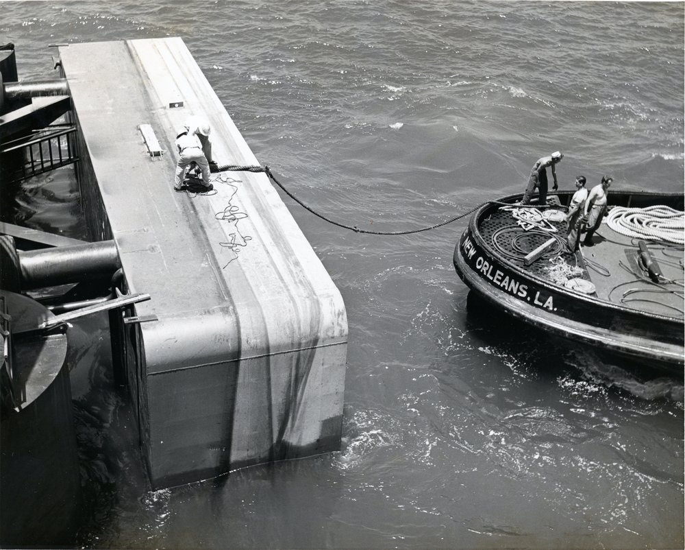 A New Orleans tub boat attaches a line to the offshore rig.